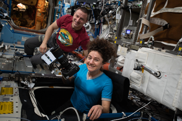 Os astronautas Jessica Meir e Andrew Morgan tiram fotos da Terra através da jane