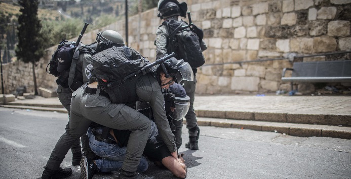 Forças de segurança israelenses prendem um manifestante palestino 