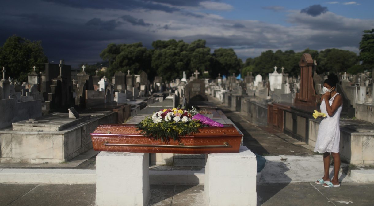 Mulher acompanha enterro da mãe, que morreu de Covid-19, em cemitério do Rio de Janeiro