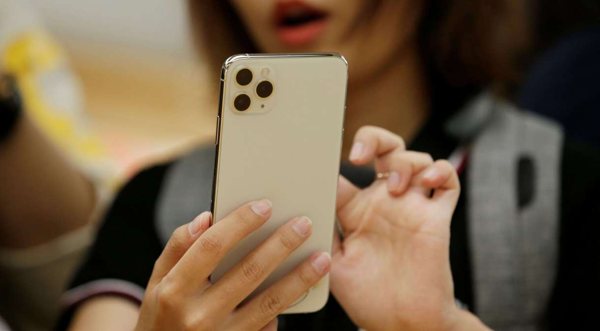 Uma mulher segura seu iPhone 11 Pro Max em Pequim, China