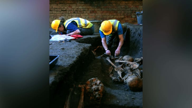 Membros da Unidade Arqueológica de Cambridge escavam esqueletos em 2010