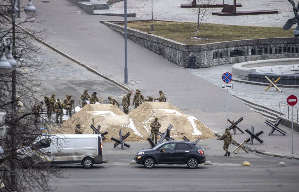 Soldados são vistos atrás de pilhas de areia usadas para bloquear uma estrada na capital ucraniana, Kiev, em meio a ataques russos em 01 de março de 2022