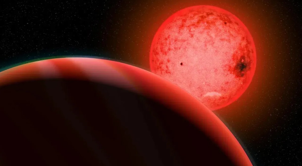A ilustração de um artista mostra um grande planeta gigante gasoso (primeiro plano) orbitando uma pequena estrela anã vermelha chamada TOI 5205.