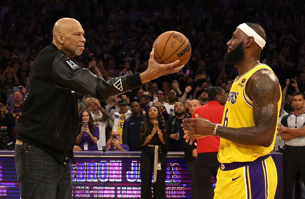 LOS ANGELES, CALIFORNIA - FEBRUARY 07: NBA Commissioner Adam Silver looks on as Kareem Abdul-Jabbar ceremoniously hands LeBron James #6 of the Los Angeles Lakers the ball after James passed Abdul-Jabbar to become the NBA's all-time leading scorer, surpassing Abdul-Jabbar's career total of 38,387 points against the Oklahoma City Thunder at Crypto.com Arena on February 07, 2023 in Los Angeles, California. NOTE TO USER: User expressly acknowledges and agrees that, by downloading and or using this photograph, User is consenting to the terms and conditions of the Getty Images License Agreement. 