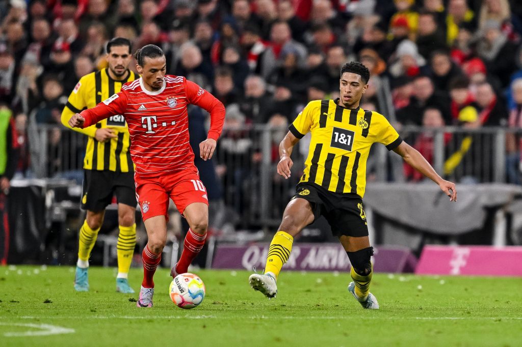 Leroy Sane, do Bayern de Munique e Jude Bellingham, do Borussia Dortmund, lutam pela bola durante a partida da Bundesliga entre o FC Bayern München e o Borussia Dortmund, na Allianz Arena, em 1º de abril de 2023
