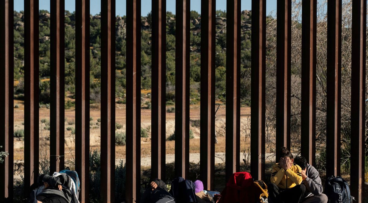 Migrantes no muro da fronteira após cruzarem do México para os EUA27/04/2024