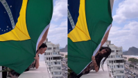 No Rio, Katy Perry aparece em janela de hotel com bandeira do Brasil; veja