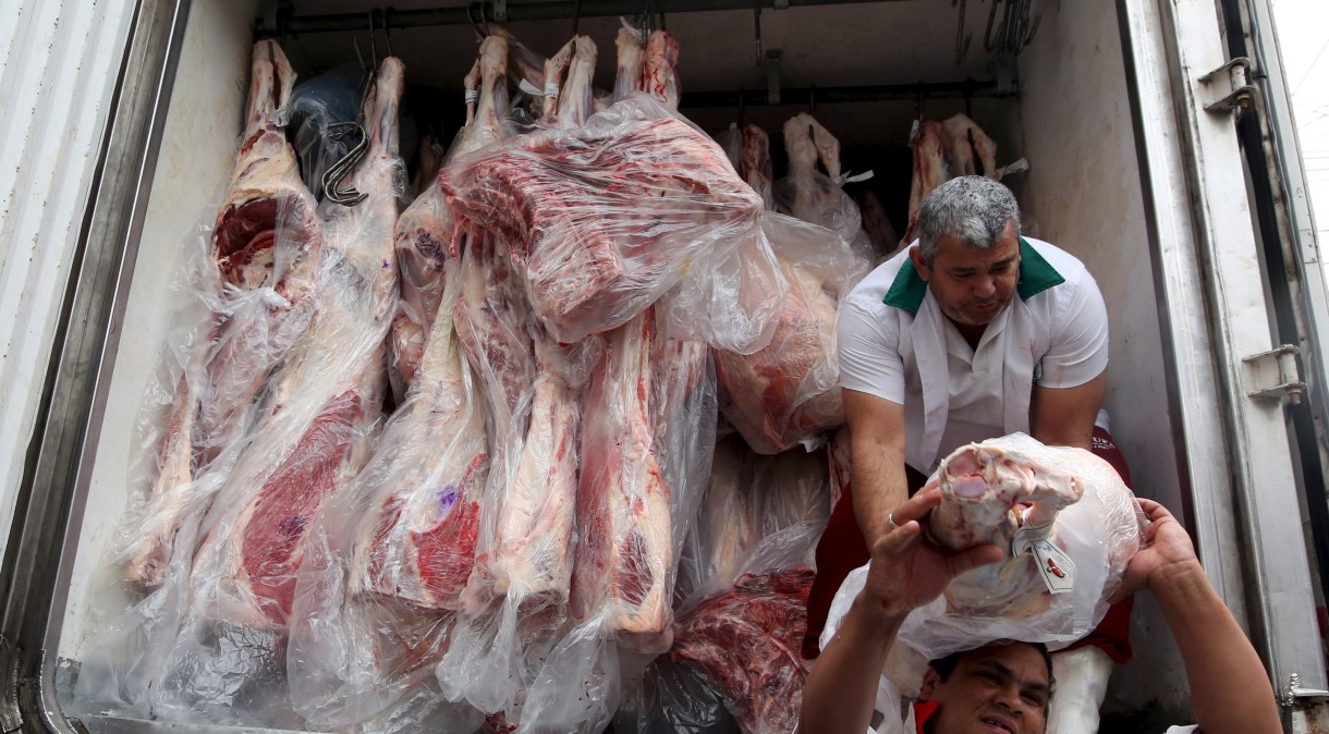 Trabalhadores descarregam caminhão com carne bovina em São Paulo