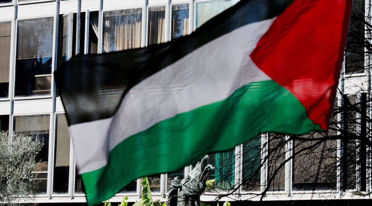 Bandeira palestina tremula em frente a estátua de cavalo de bronze, símbolo da emissora estatal italiana RAI, na sede do veículo em Roma, durante protesto contra a cobertura do conflito entre Israel e o grupo islâmico palestino Hamas em Gaza